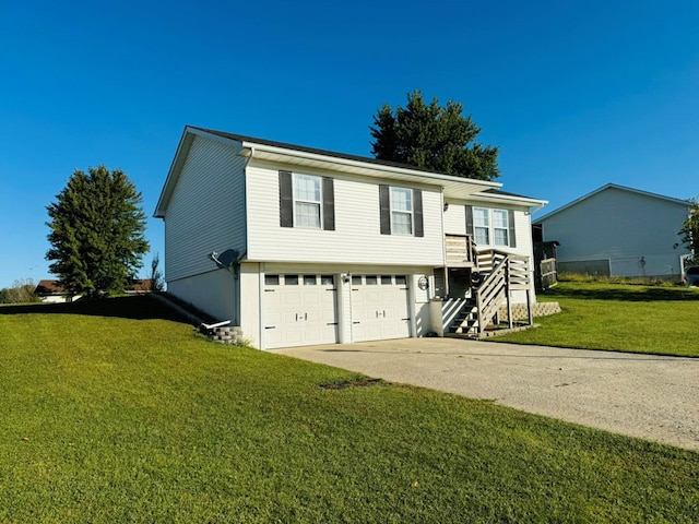 split foyer home with a garage and a front lawn