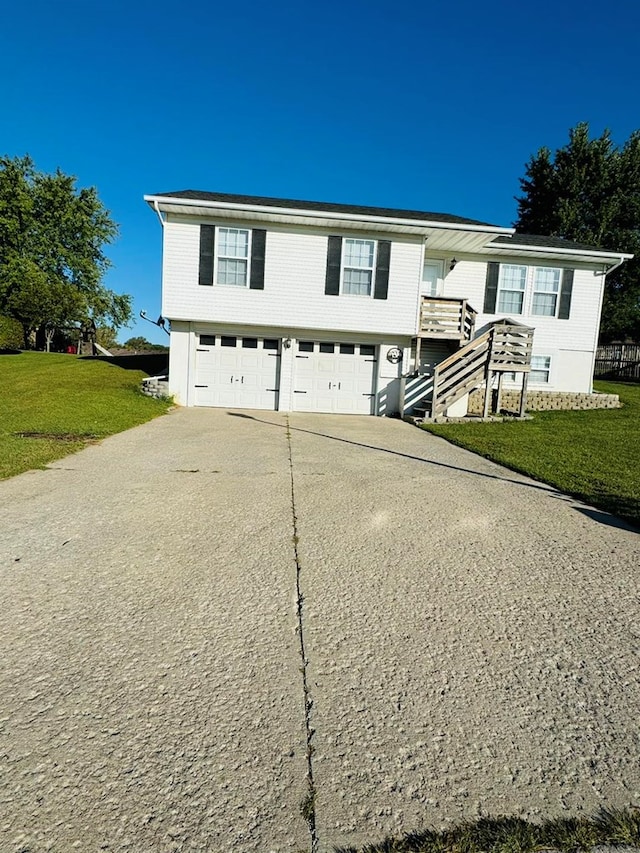 bi-level home featuring a front lawn and a garage