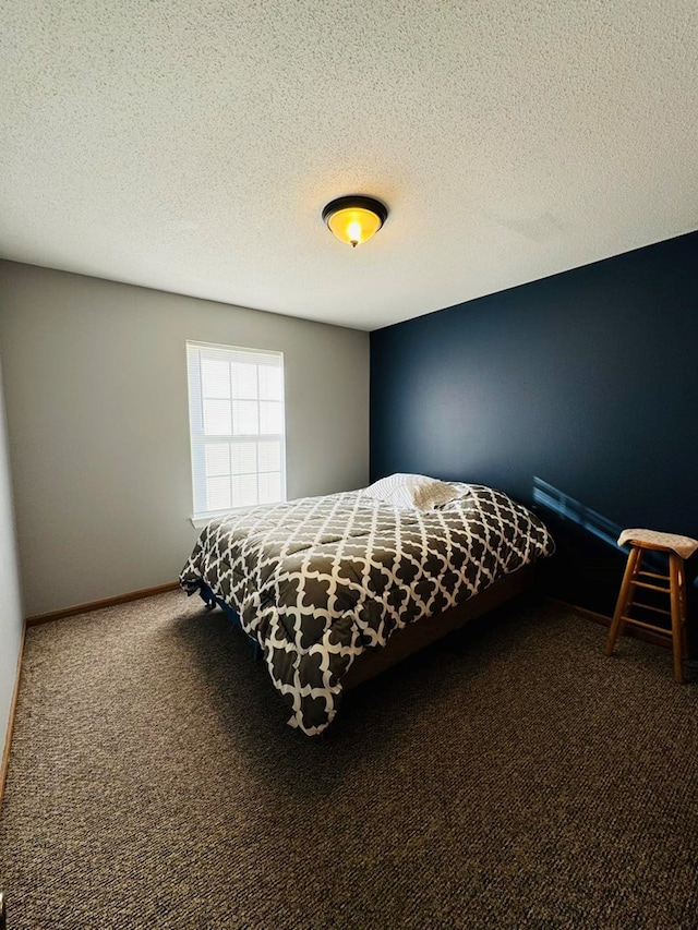 bedroom with carpet and a textured ceiling