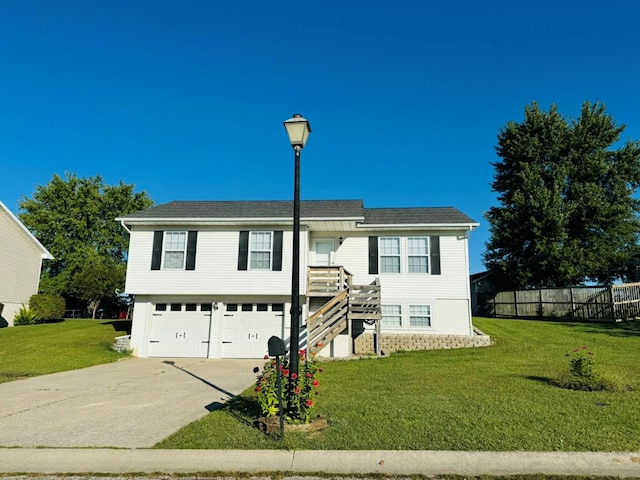 bi-level home with a front lawn and a garage