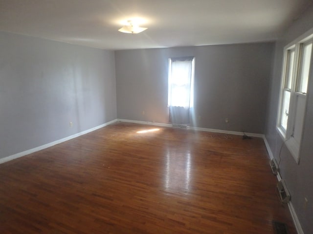 302 N King St, Brashear, MO 63533 - empty room featuring wood finished floors, a wealth of natural light, and baseboards