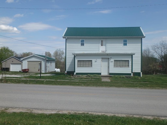 302 N King St, Brashear, MO 63533 - view of front facade featuring a garage, an outbuilding, and metal roof