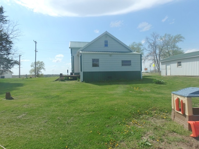 302 N King St, Brashear, MO 63533 - view of side of home with a lawn and metal roof