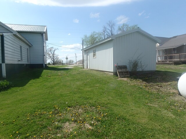 302 N King St, Brashear, MO 63533 - view of home's exterior with a lawn and metal roof