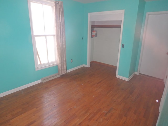 302 N King St, Brashear, MO 63533 - unfurnished bedroom featuring wood finished floors, a closet, and baseboards