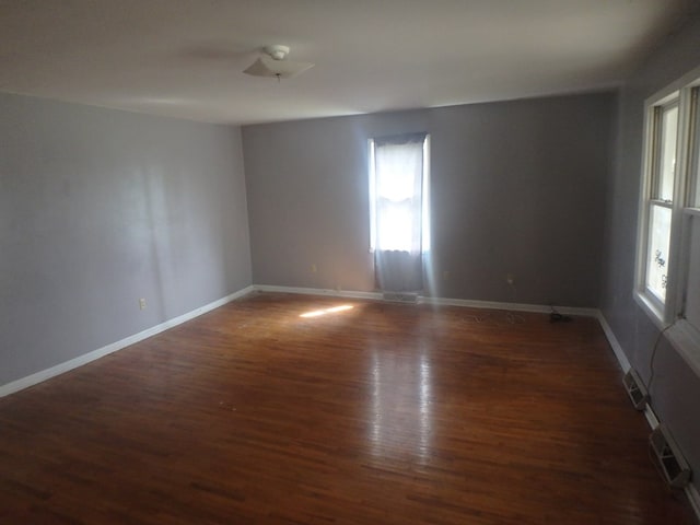 302 N King St, Brashear, MO 63533 - empty room with baseboards, wood finished floors, and visible vents