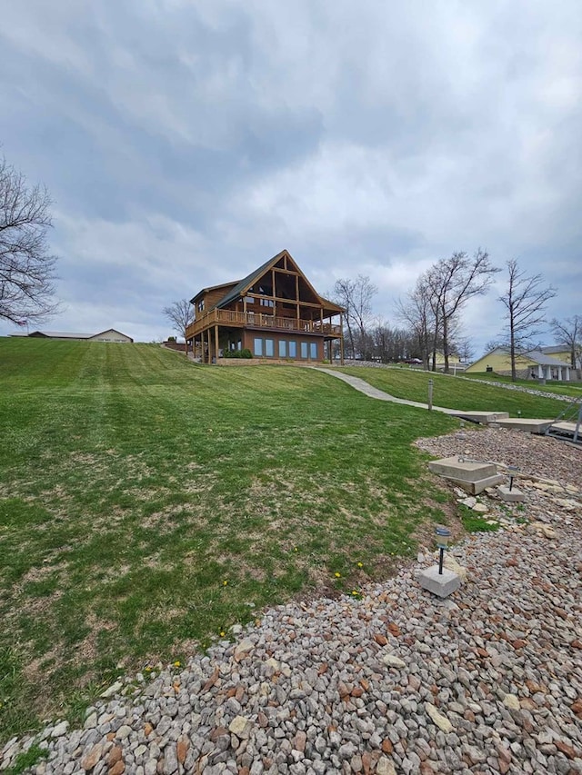 rear view of property featuring a wooden deck and a yard