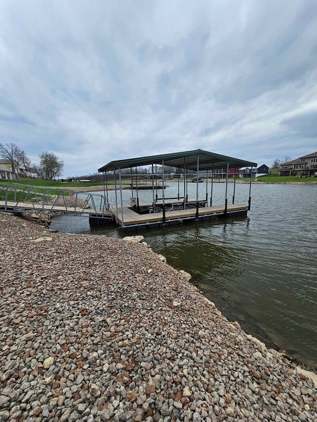 dock area with boat lift and a water view