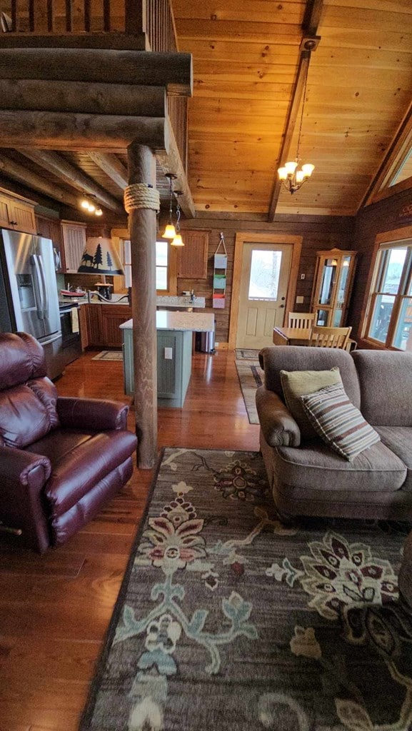 living area featuring wooden ceiling, wood finished floors, and a wealth of natural light