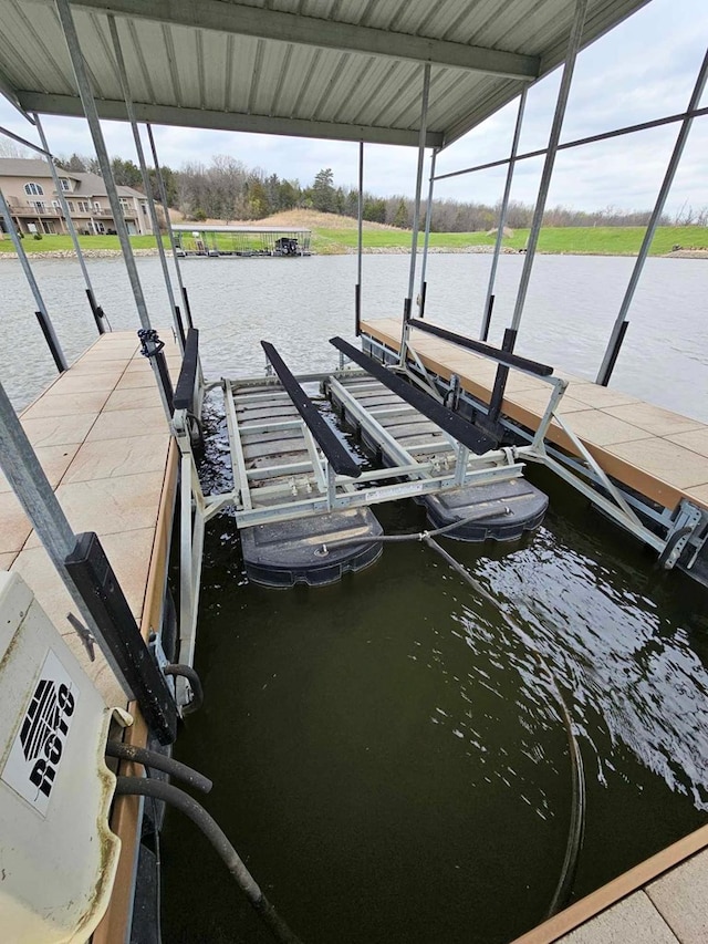 view of dock with boat lift and a water view