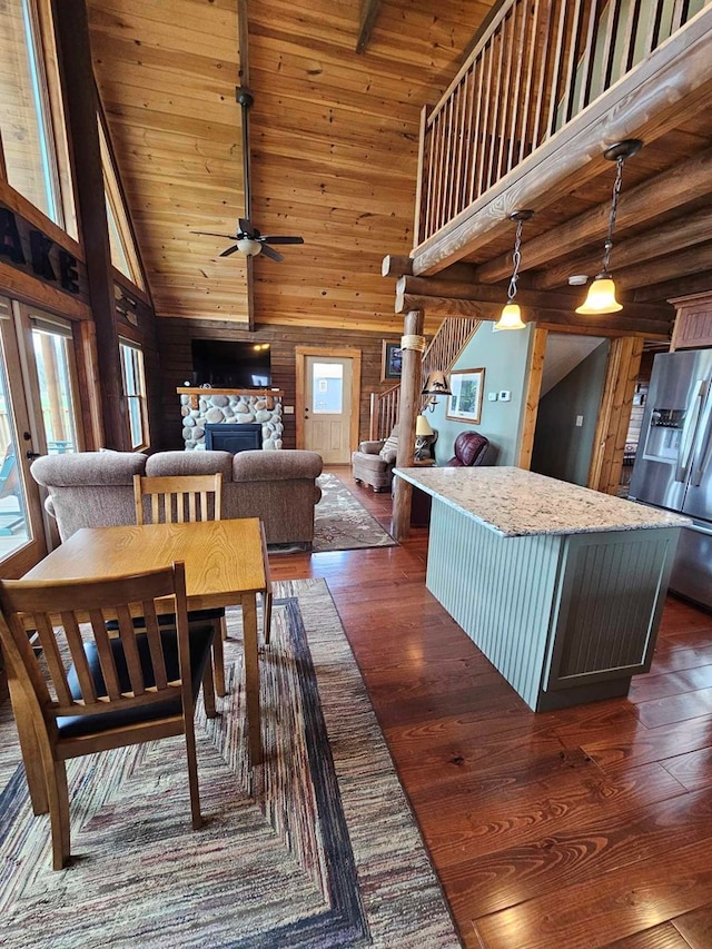 dining space with dark wood finished floors, a wealth of natural light, high vaulted ceiling, and ceiling fan
