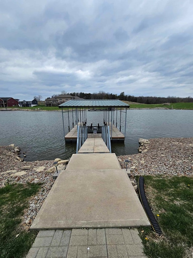 view of dock featuring boat lift and a water view