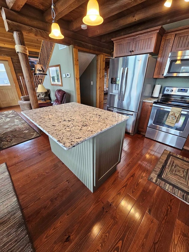 kitchen featuring pendant lighting, appliances with stainless steel finishes, dark wood-type flooring, and beam ceiling