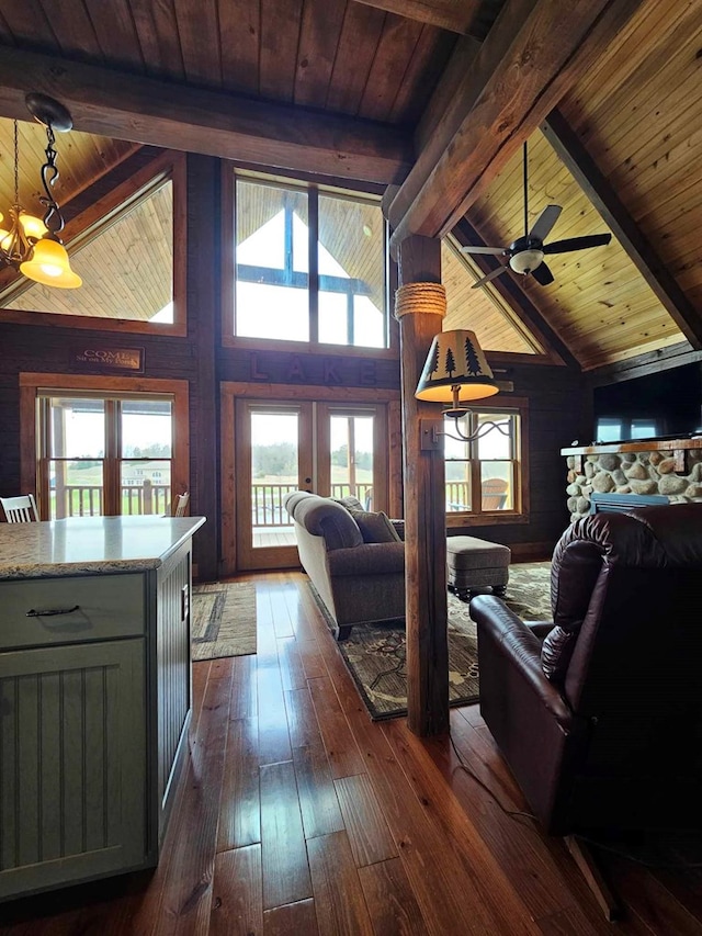 living room with dark wood finished floors, beam ceiling, wooden ceiling, and french doors