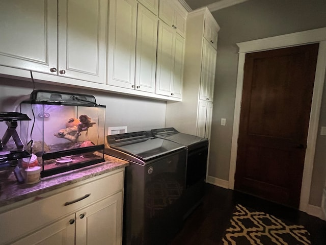 washroom featuring washing machine and clothes dryer and cabinets