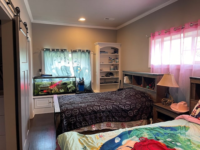 bedroom with a barn door, dark hardwood / wood-style flooring, and ornamental molding