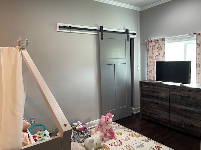 bedroom with dark hardwood / wood-style flooring, a barn door, and ornamental molding