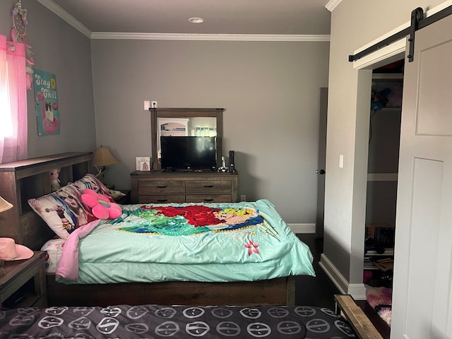 bedroom featuring a barn door and ornamental molding