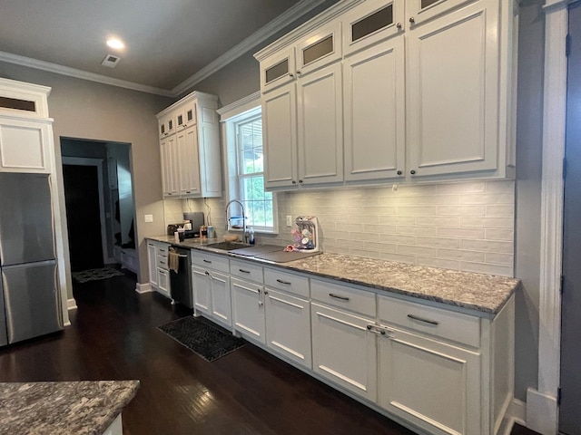 kitchen with light stone counters, stainless steel dishwasher, sink, dark hardwood / wood-style floors, and white cabinetry