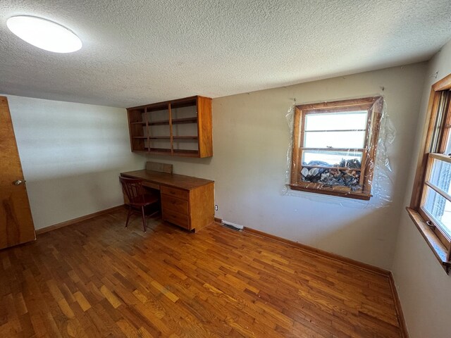 2116 S Franklin St, Kirksville, MO 63501 - unfurnished office featuring wood finished floors and a textured ceiling