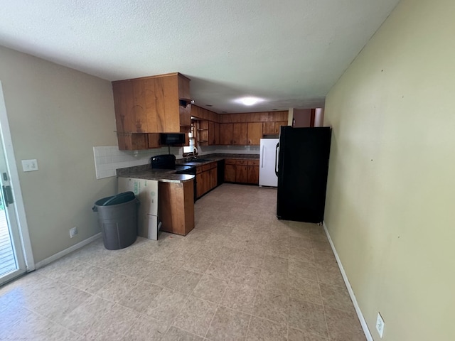 2116 S Franklin St, Kirksville, MO 63501 - kitchen featuring black appliances, brown cabinets, and dark countertops