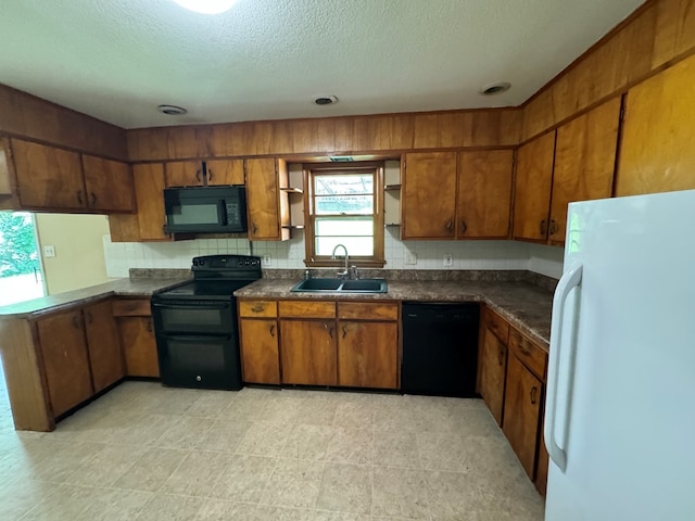2116 S Franklin St, Kirksville, MO 63501 - kitchen featuring black appliances, dark countertops, brown cabinetry, and a textured ceiling