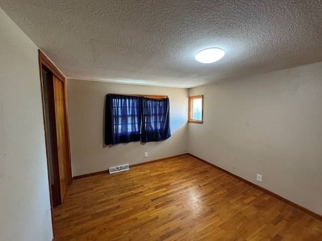 2116 S Franklin St, Kirksville, MO 63501 - unfurnished room with wood finished floors and a textured ceiling
