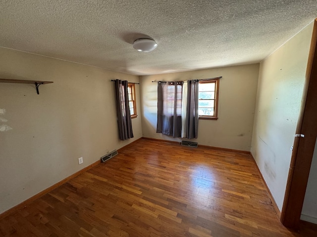 2116 S Franklin St, Kirksville, MO 63501 - spare room with wood finished floors and a textured ceiling