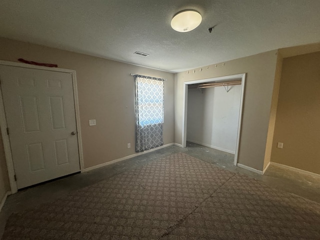 2116 S Franklin St, Kirksville, MO 63501 - unfurnished bedroom with a textured ceiling, a closet, and carpet flooring