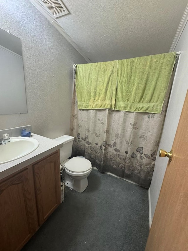 bathroom featuring vanity, toilet, ornamental molding, and a textured ceiling