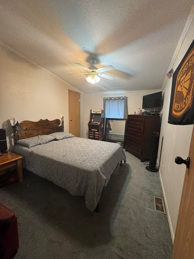 carpeted bedroom featuring ceiling fan, a textured ceiling, and ornamental molding