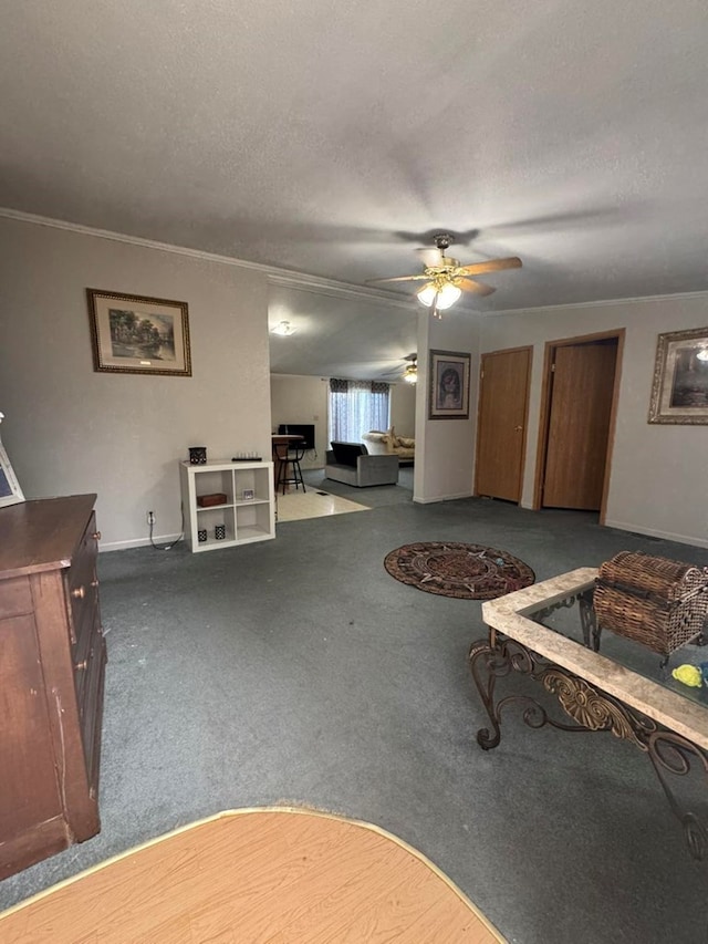 carpeted living room featuring ceiling fan, a textured ceiling, and ornamental molding