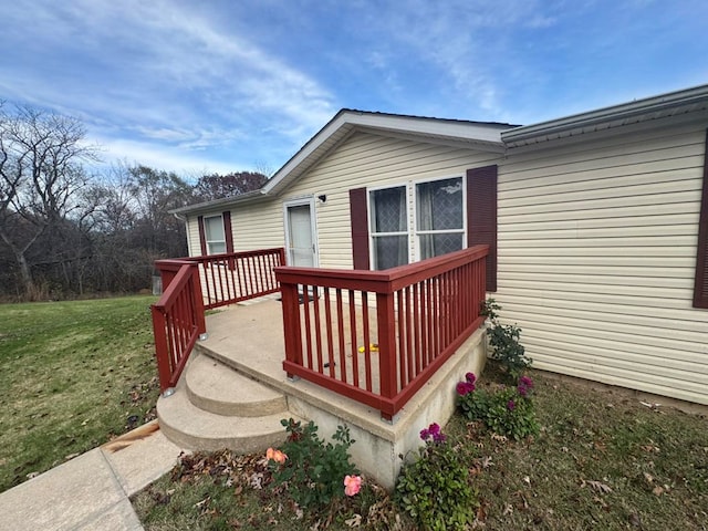 wooden terrace featuring a yard