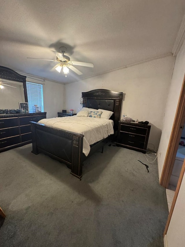 bedroom with carpet, ceiling fan, and a textured ceiling