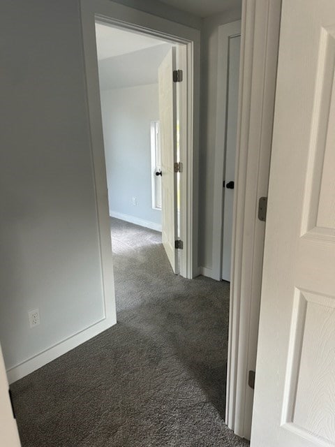 corridor with dark colored carpet