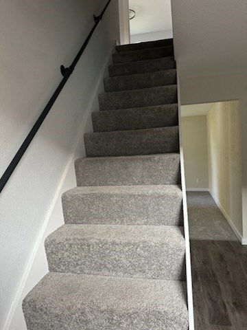 stairway with hardwood / wood-style flooring