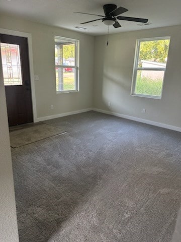 spare room with carpet and ceiling fan