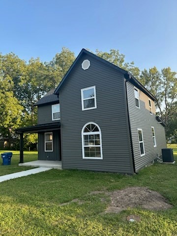 view of property exterior with a lawn, central air condition unit, and a patio area