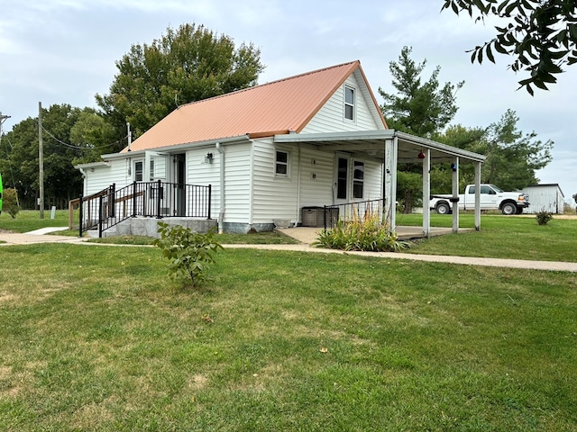 rear view of house featuring a lawn