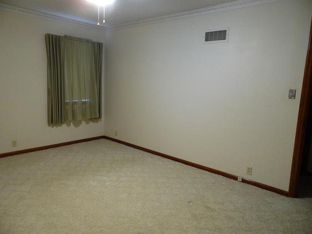 empty room featuring light colored carpet and ornamental molding