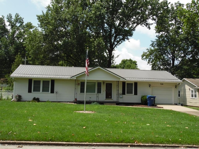 ranch-style home featuring covered porch, a garage, and a front yard