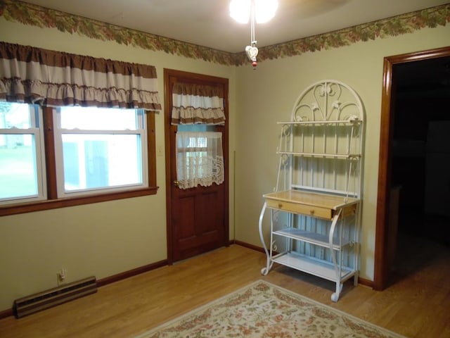 entrance foyer featuring hardwood / wood-style flooring, ceiling fan, and a healthy amount of sunlight