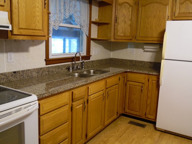 kitchen featuring white appliances, light hardwood / wood-style floors, range hood, and sink