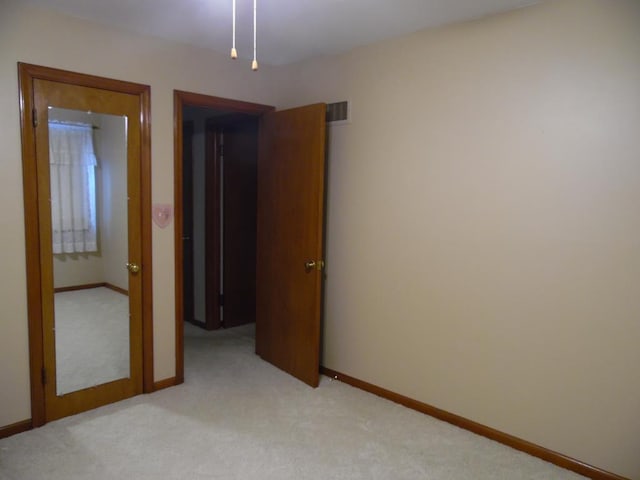 unfurnished bedroom featuring light colored carpet