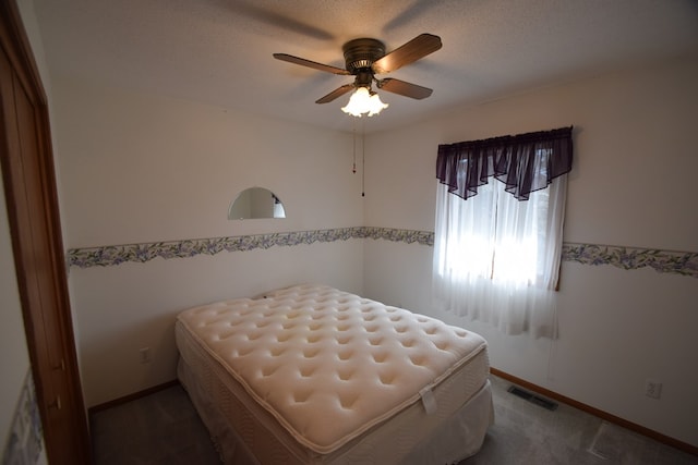 bedroom with baseboards, visible vents, and ceiling fan