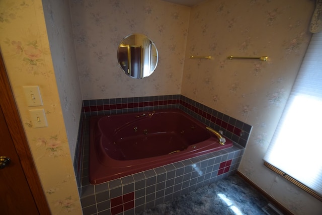 bathroom with a garden tub and wallpapered walls