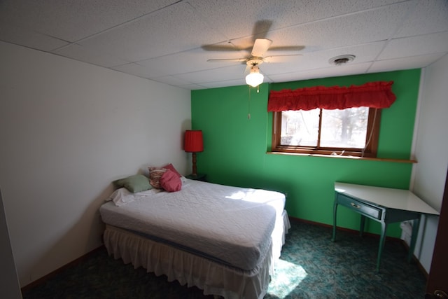 carpeted bedroom with visible vents, a paneled ceiling, and ceiling fan