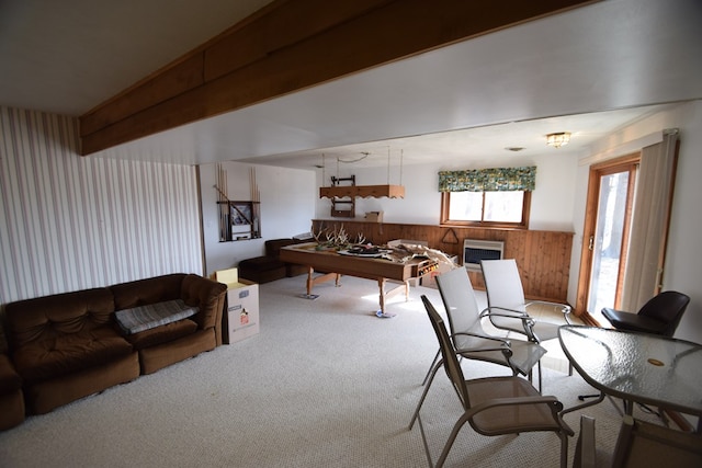 interior space featuring a wall mounted air conditioner, beamed ceiling, carpet, wood walls, and wainscoting