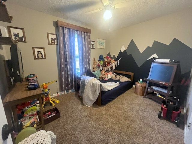 carpeted bedroom with ceiling fan, baseboards, and a textured ceiling