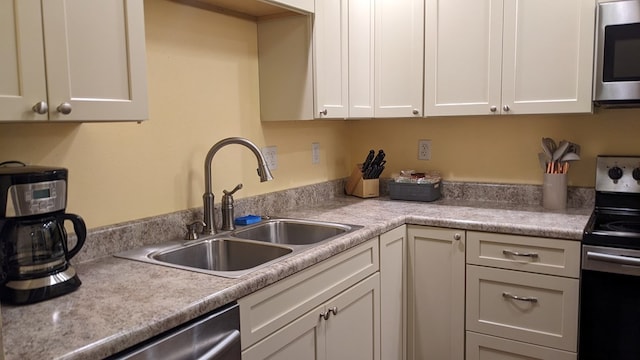 kitchen with white cabinets, sink, and stainless steel appliances